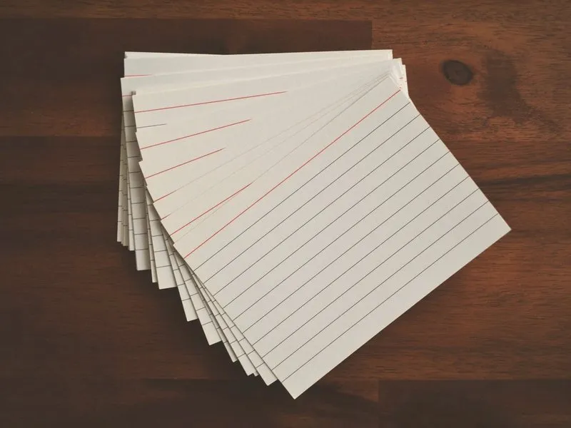 A fanned stack of lined index cards