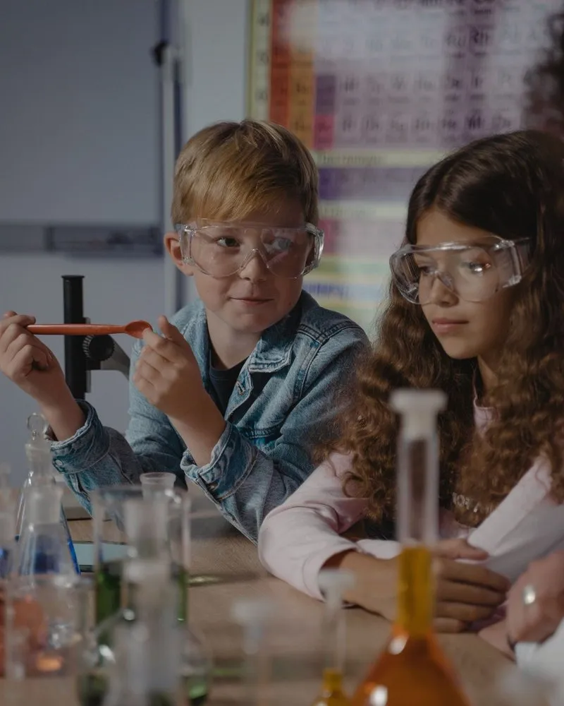 Two students examine the result of their experiment closely